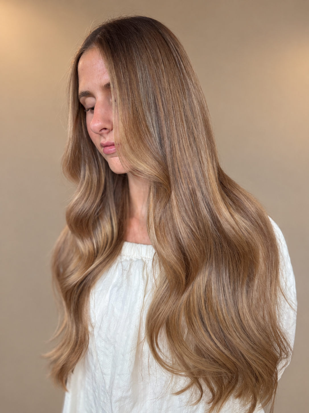 Sun-kissed bronde waves with soft honey highlights created by Hannah
